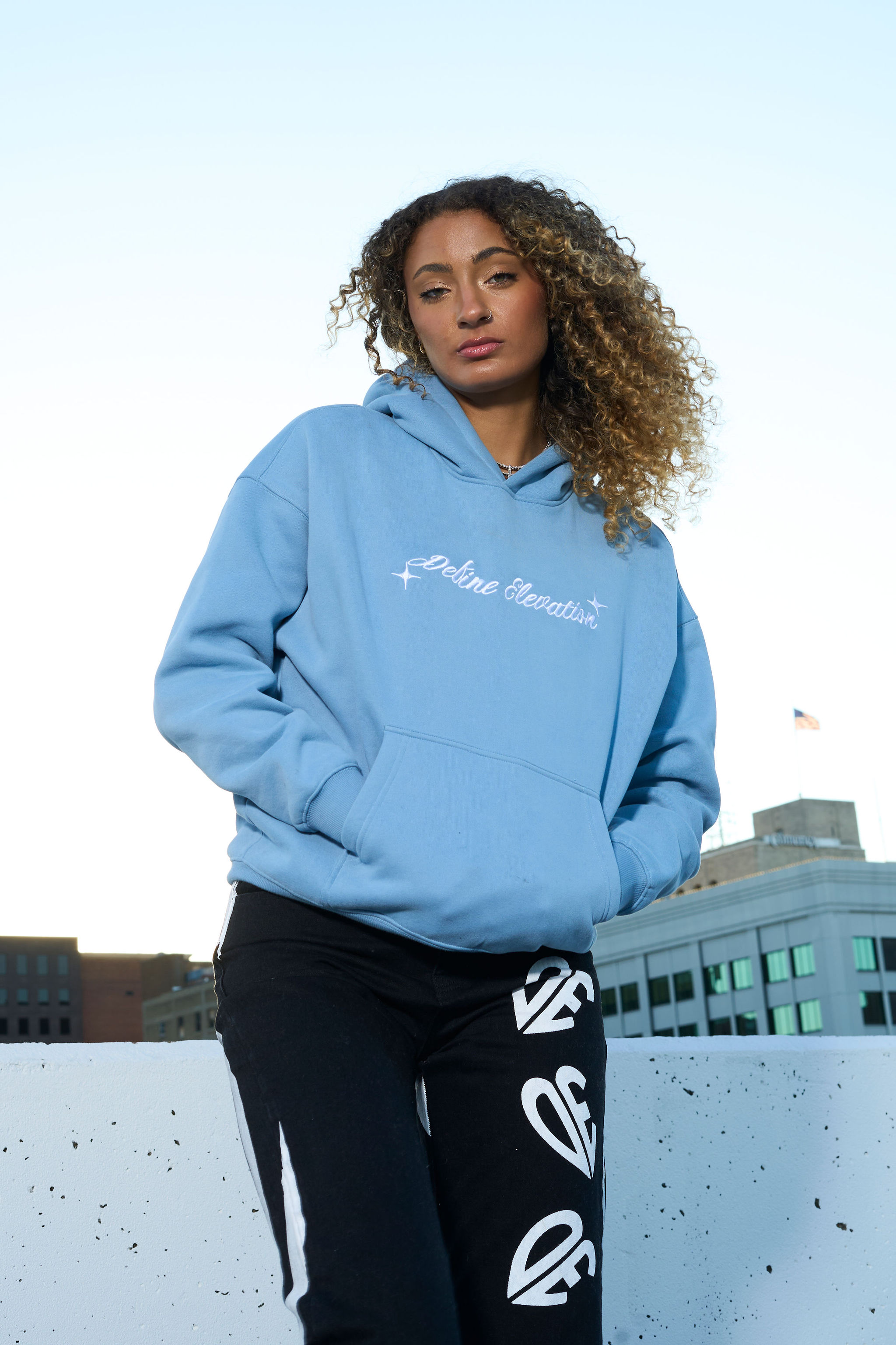 Blue hoodie rooftop portrait
