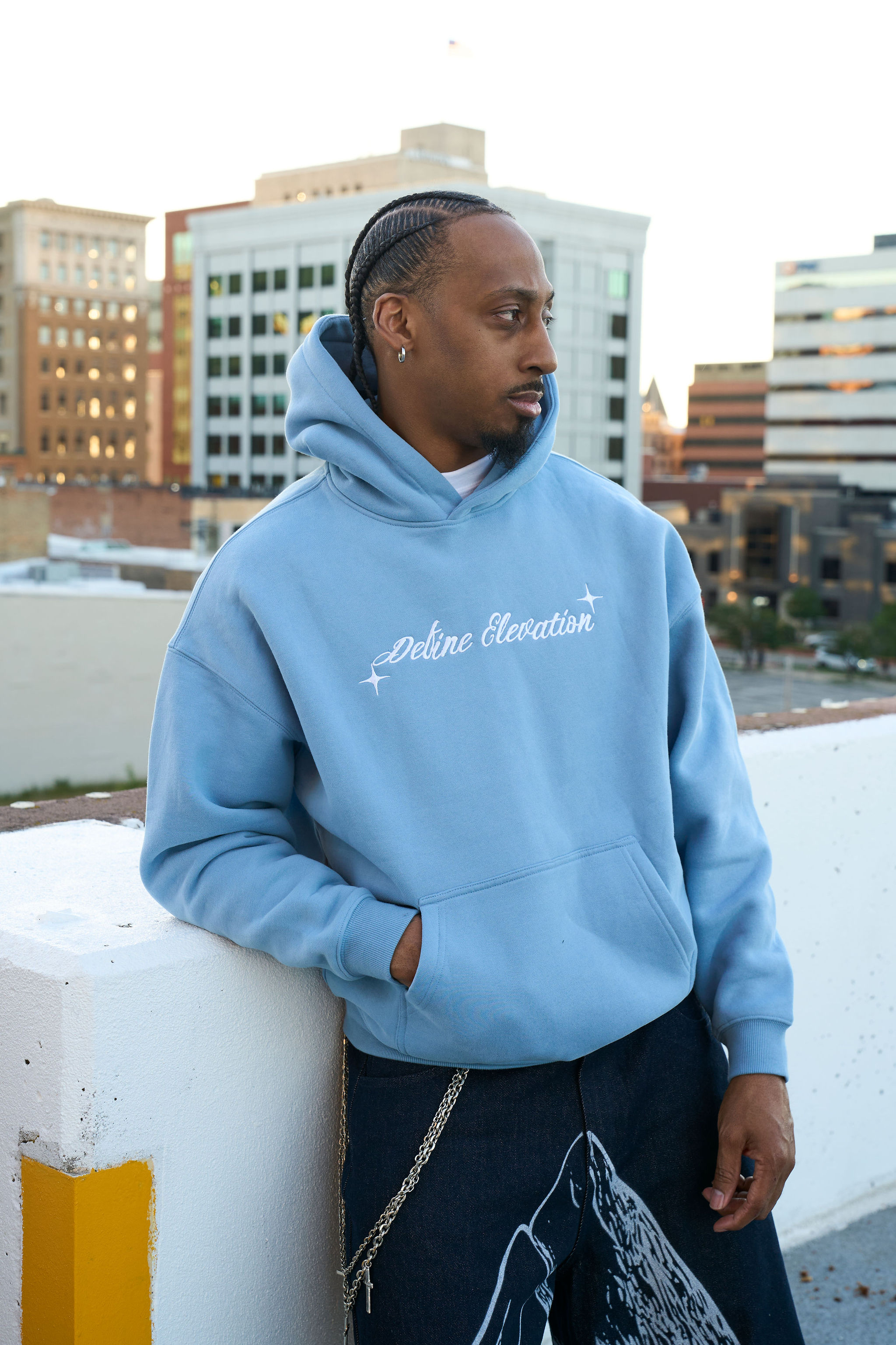 Light-blue Define Elevation hoodie rooftop campaign